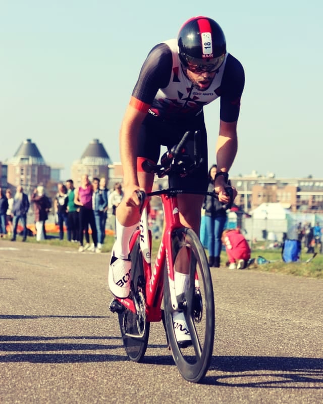 Professional triathlete in aerodynamic time trial position during race