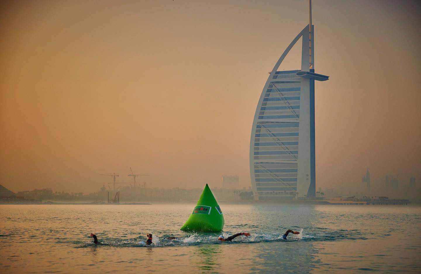 Open water swimming training with iconic Dubai skyline backdrop