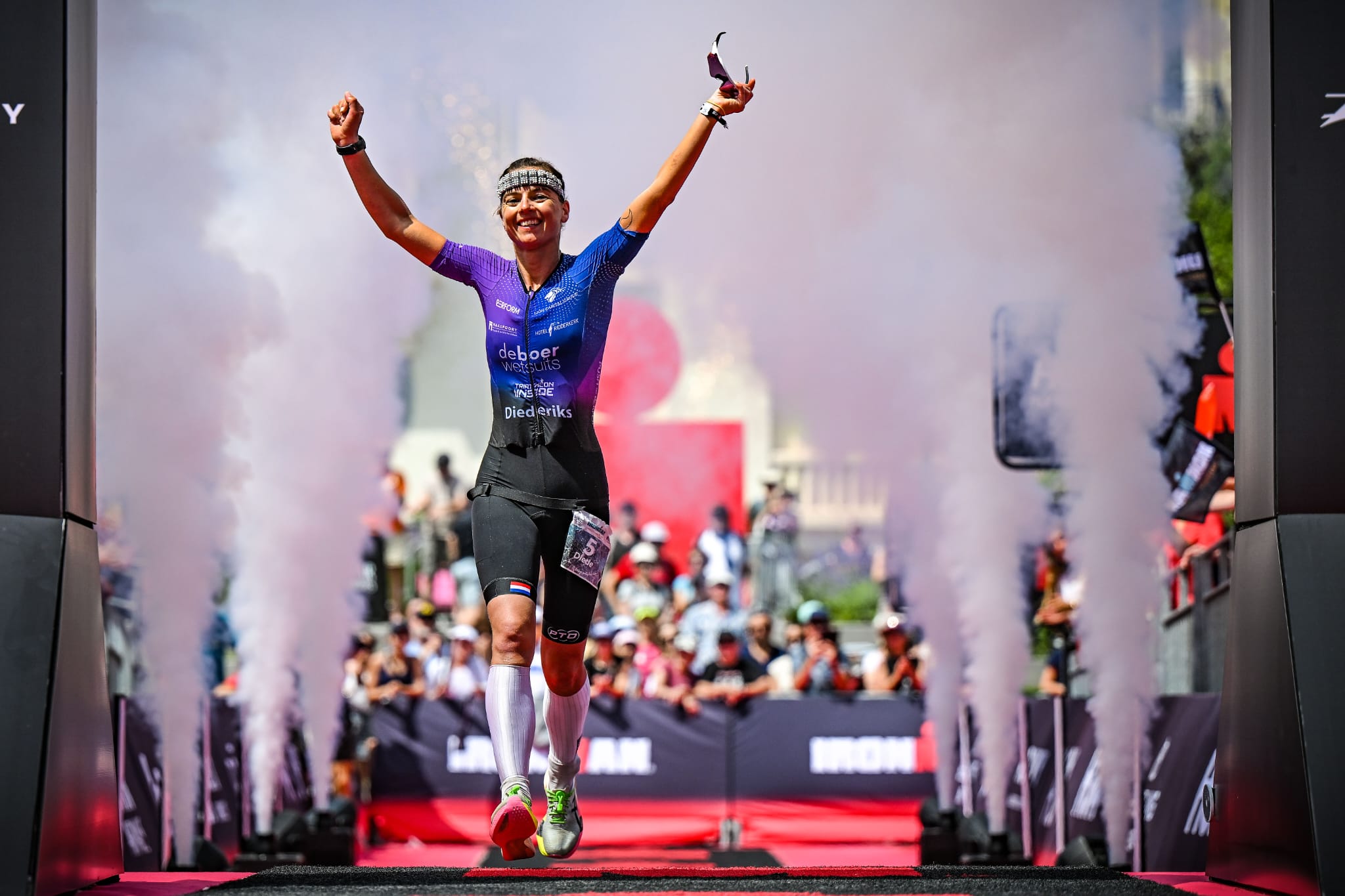 Professional triathlete celebrating victory at finish line